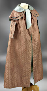Cloak with capelets, arm slits and piped-bound edgings-side view